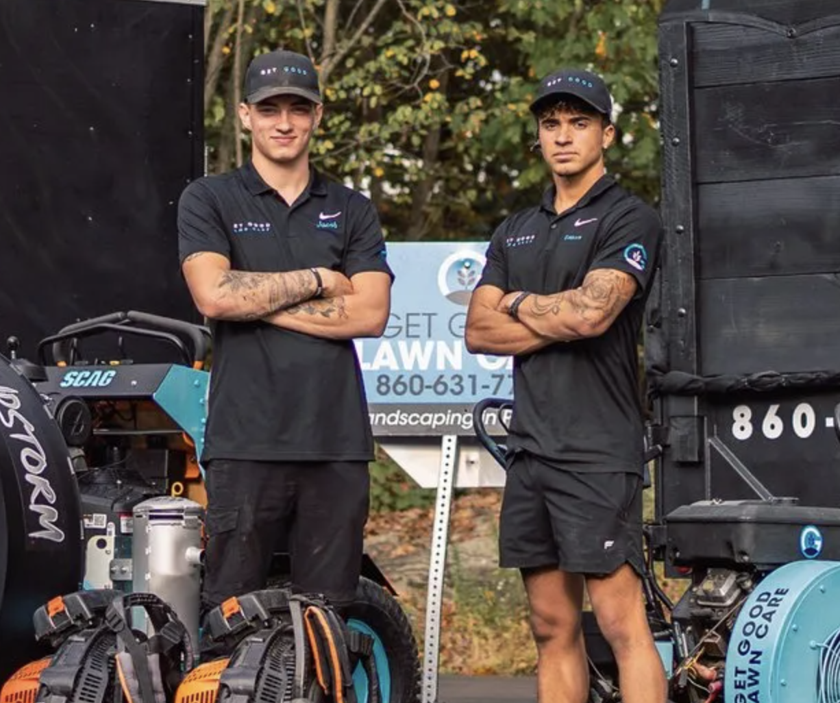 Gennaro and Jacob, the crew behind Get Good Lawn Care, in front of their truck and equipment